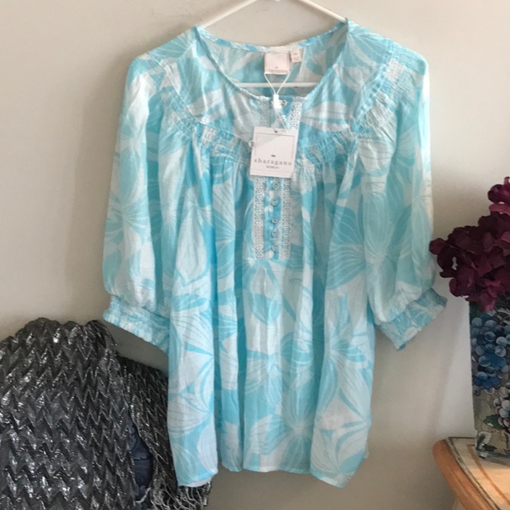 Lovely light weight robin’s egg blue and white top. Size 2X